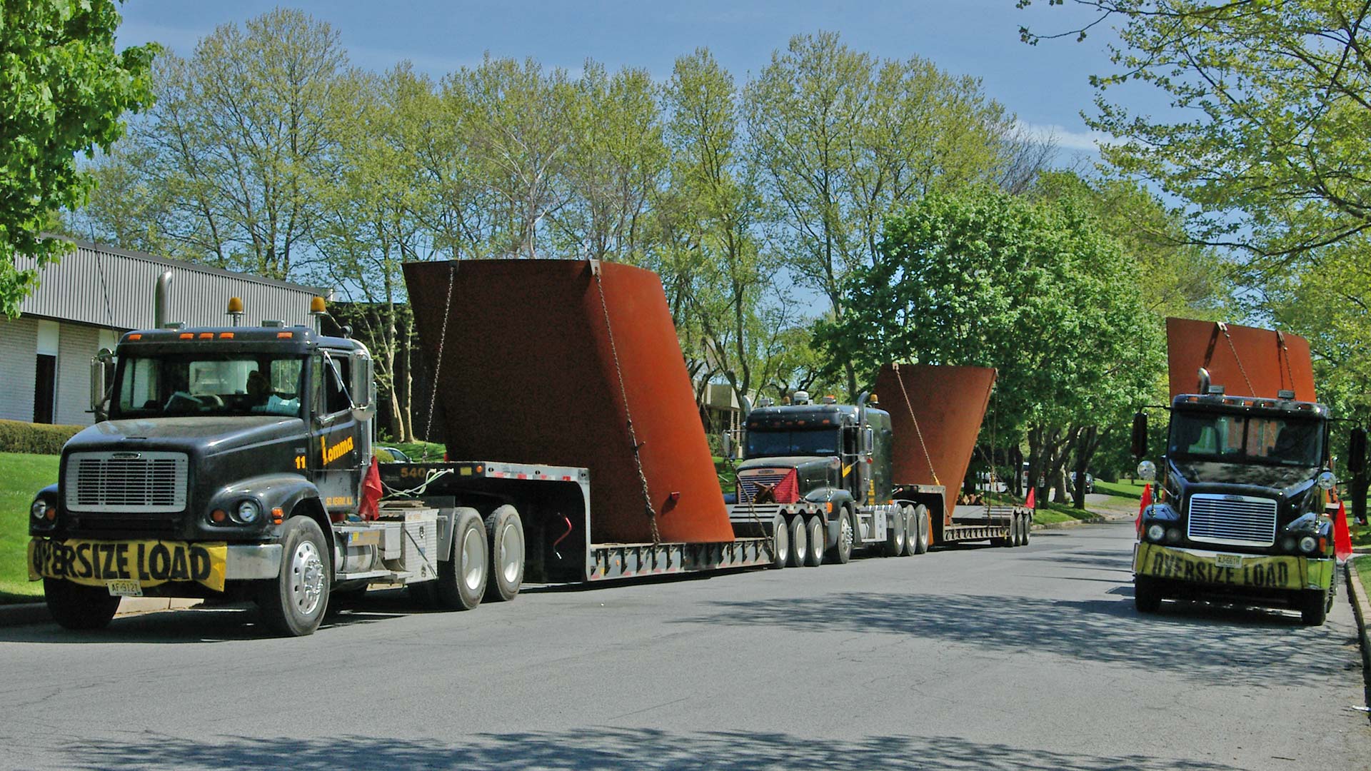 image of Richard Serra's sculpture on flatbed trucks