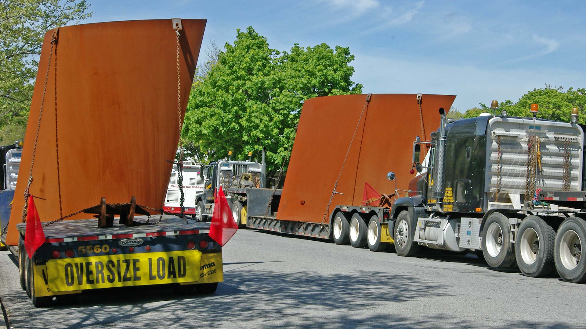 image of Richard Serra's sculpture on flatbed trucks