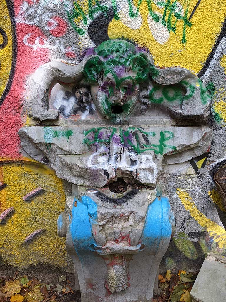 image of a fountain covered in graffiti