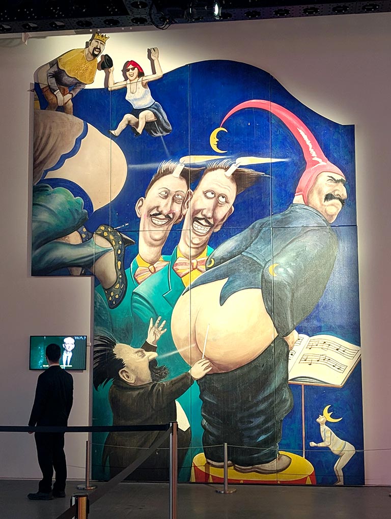 image of painted mural of a man farting in a music conductors face