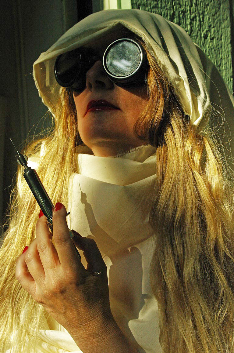 image of a woman holding an old fashioned hypodermic needle